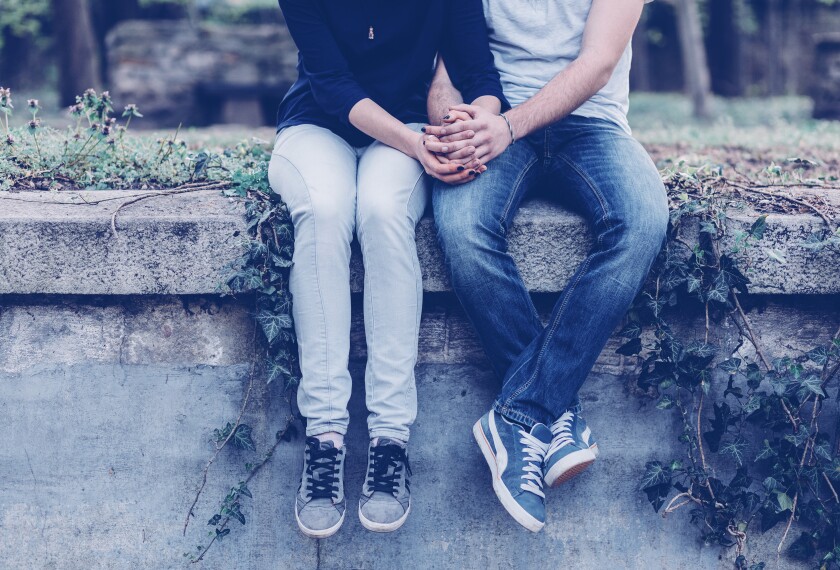 Getty; Two teenage lovers holding hands.