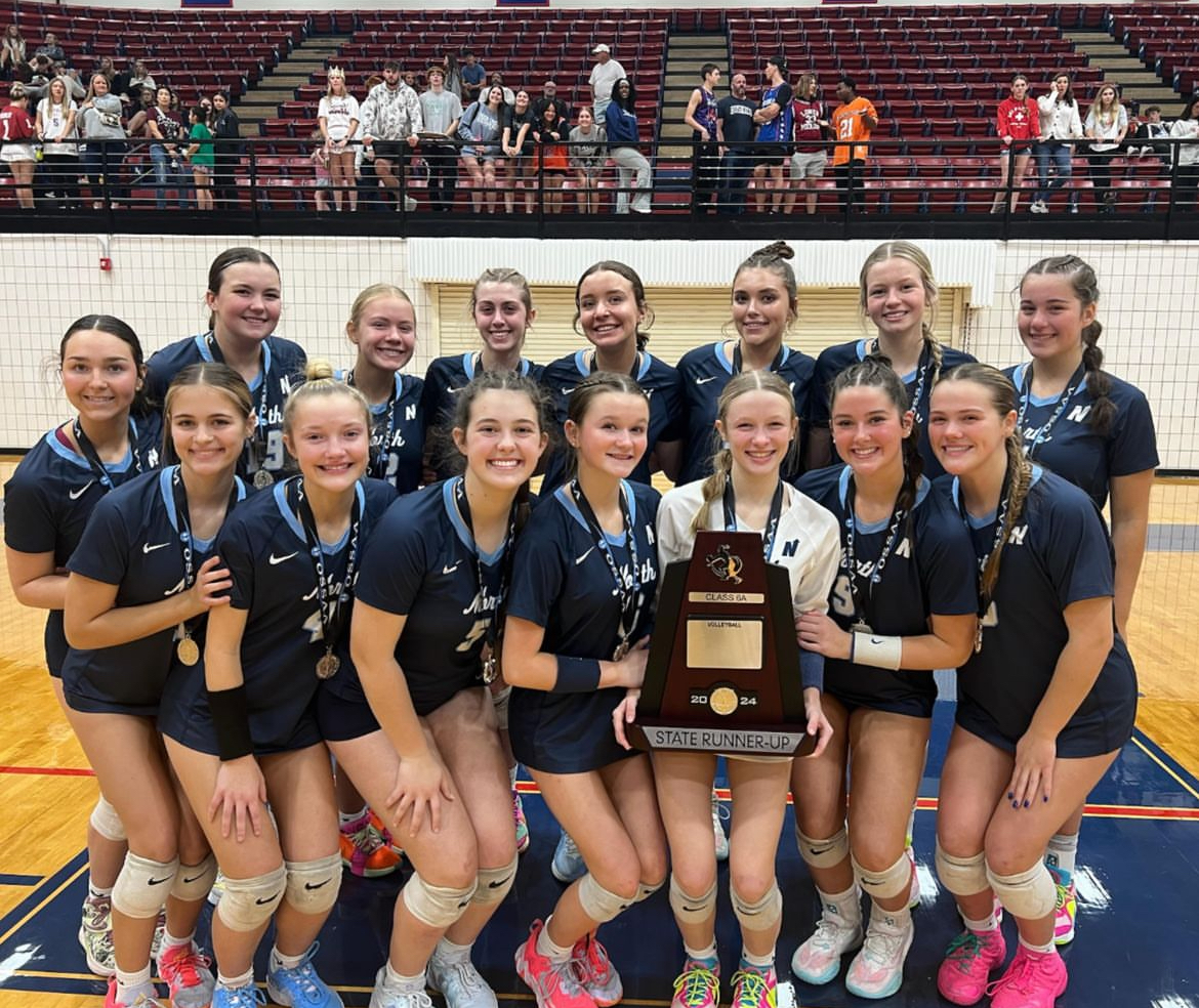 Edmond North’s volleyball team posing with the runner-up trophy. (Photo from @edmondnorthvball on Instagram.)