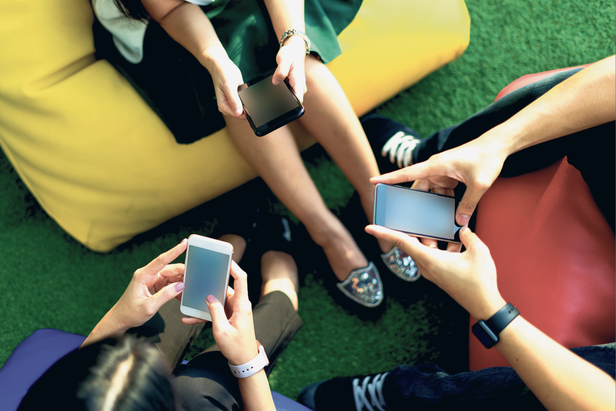 A group of students on their phones (photo taken from JewishStandard.com)