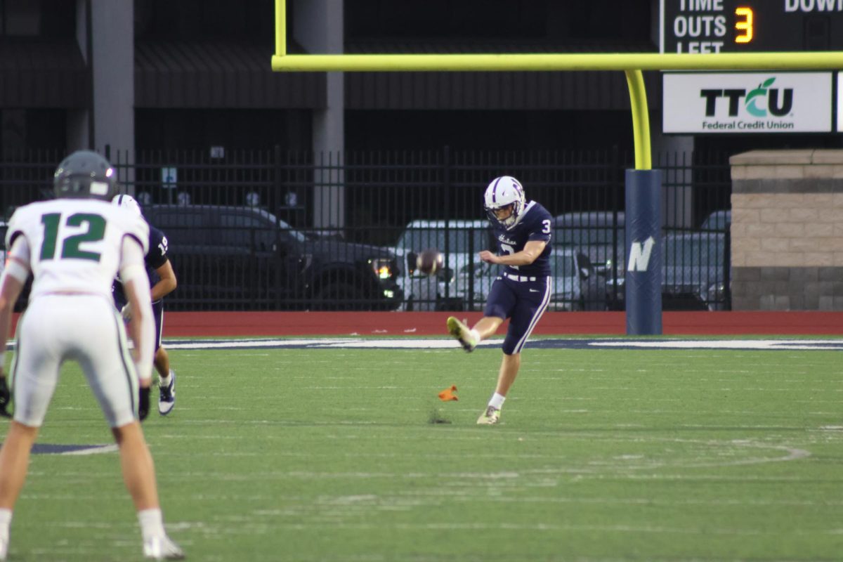 Number 3 kicking the football into play.