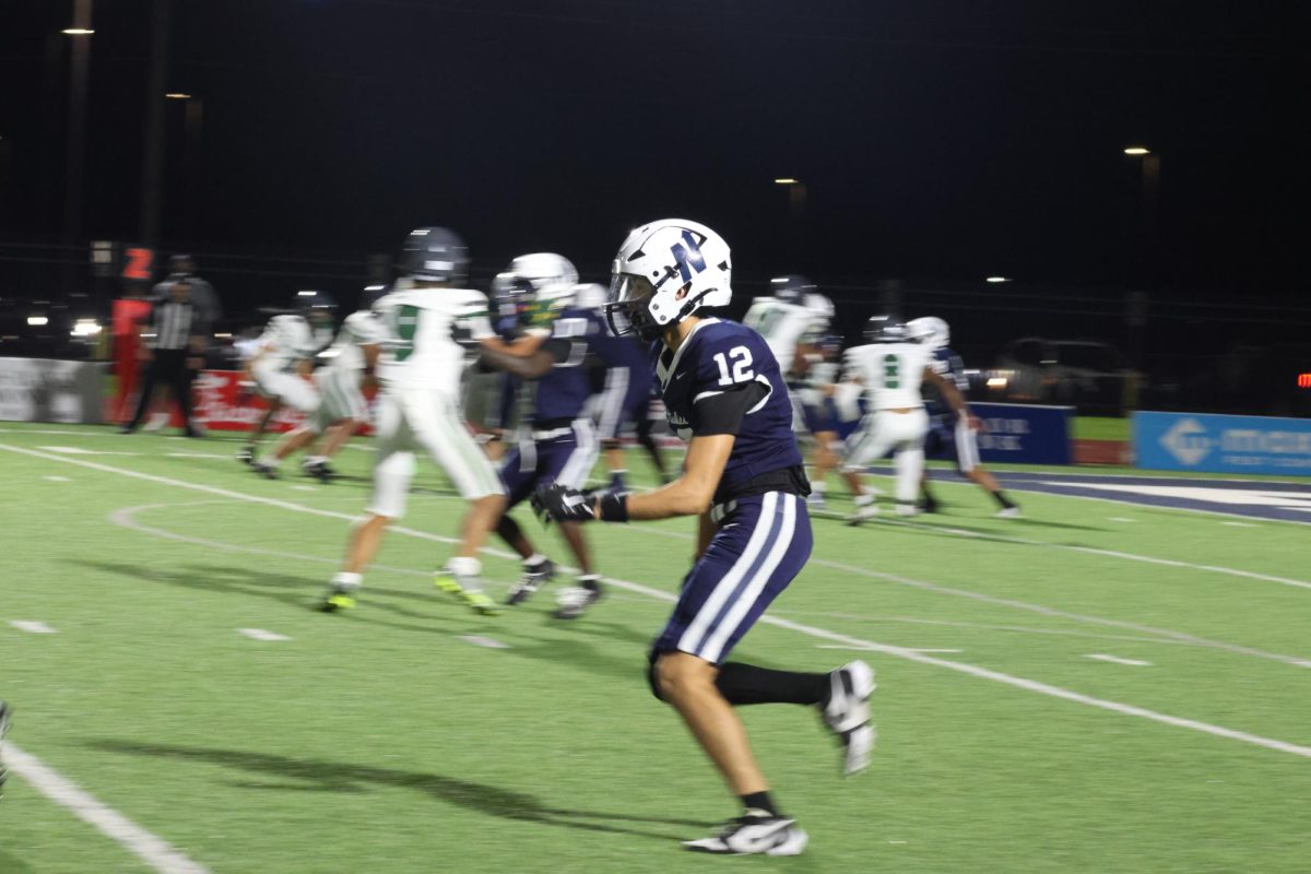 Number 12 running to catch the football.