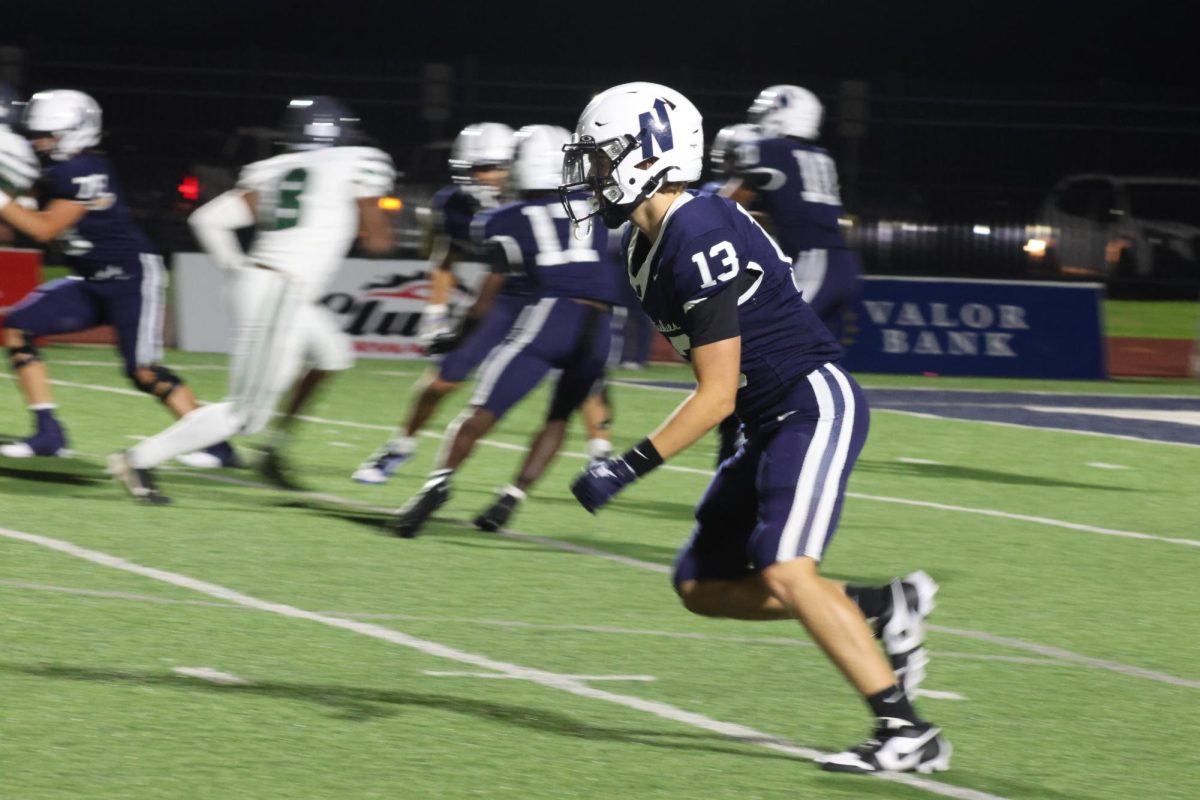 Number 13 running to catch the football.