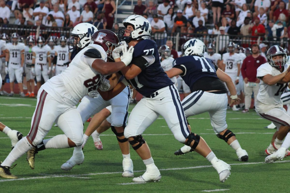 Number 77 blocking the Edmond Memorial Bulldogs.