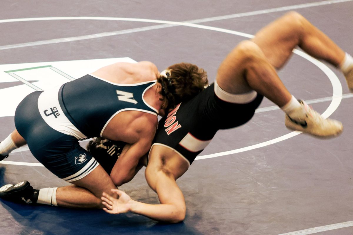 Senior Joseph Jeter dumps his opponent to his back. His unorthodox style of wrestling is what got him the six point win for Edmond North.