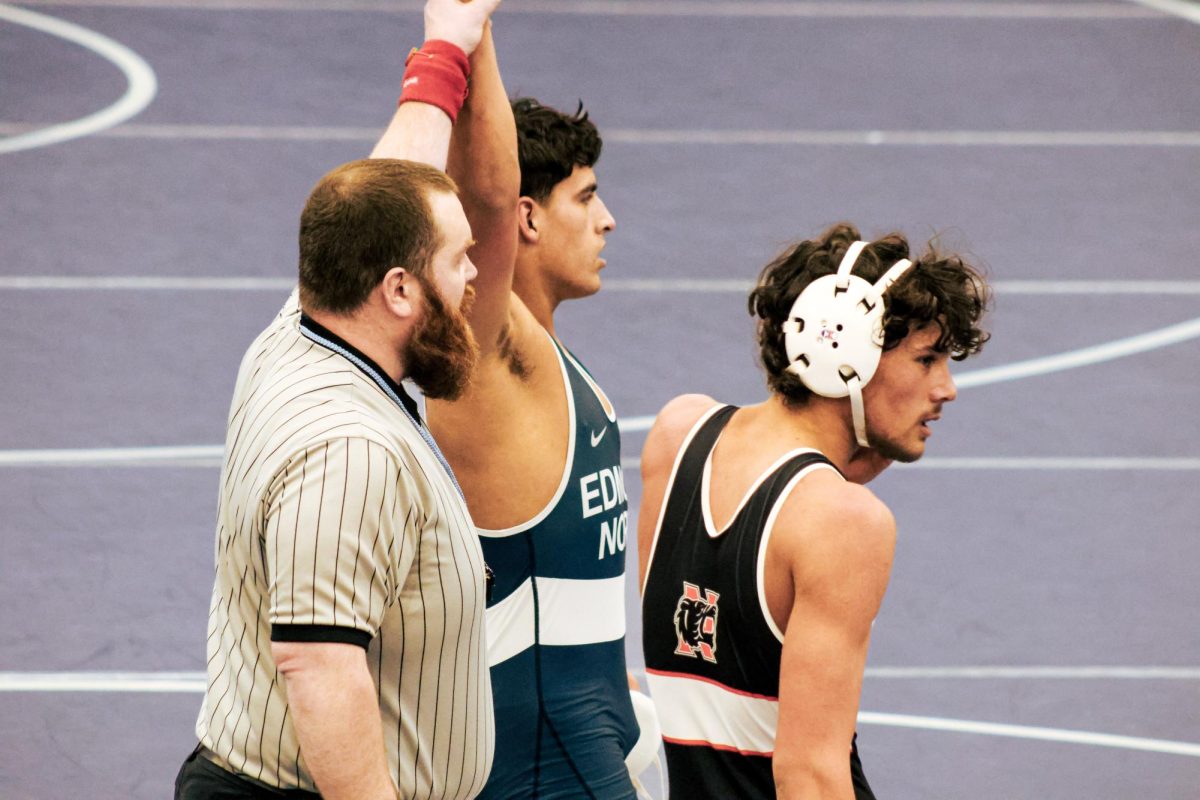 Senior Levi White wins over his opponent, scoring another six points for the team and setting the score to 57-3.
