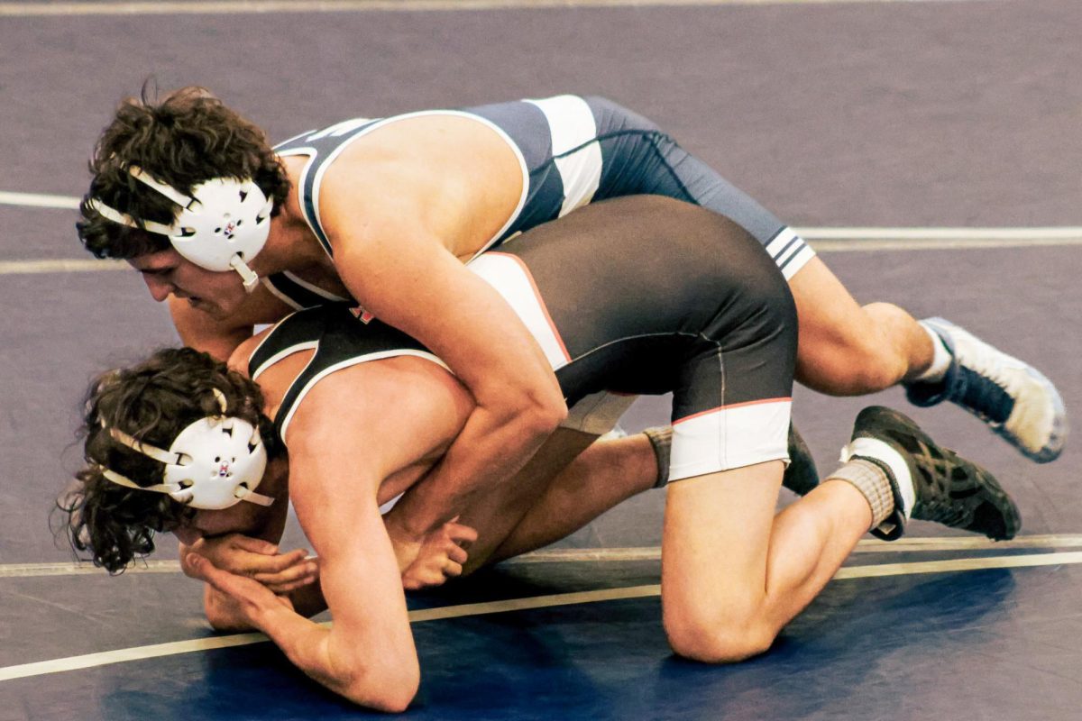 Senior Levi White grabs his opponent’s wrist to turn him onto his back. After running two tilts, White eventually gets the fall.